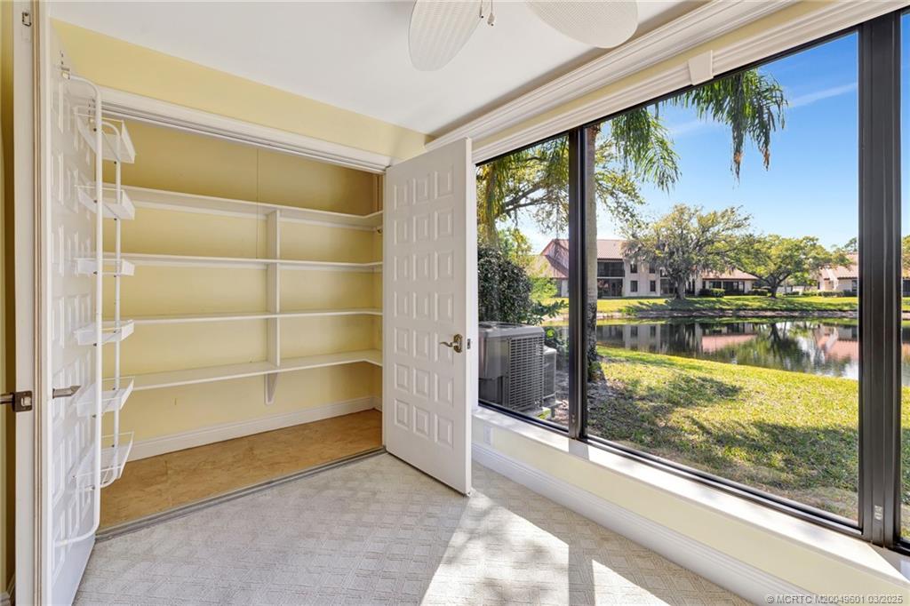 6040 Southeast Martinique Drive, Unit 102 Stuart, FL 34997 - Photo 34 of 52 a view of a room with a large window and wooden floor