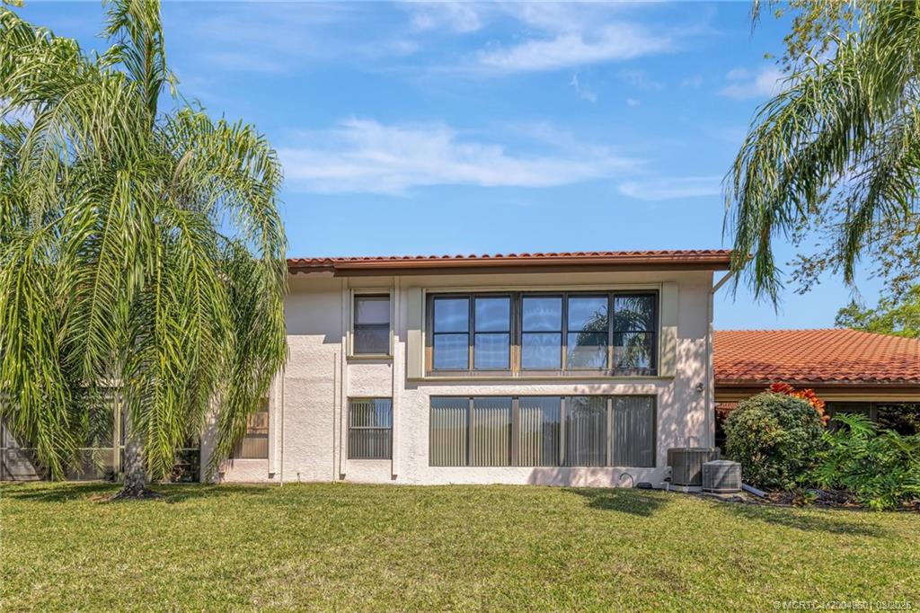 6040 Southeast Martinique Drive, Unit 102 Stuart, FL 34997 - Photo 37 of 52 front view of a building with a yard