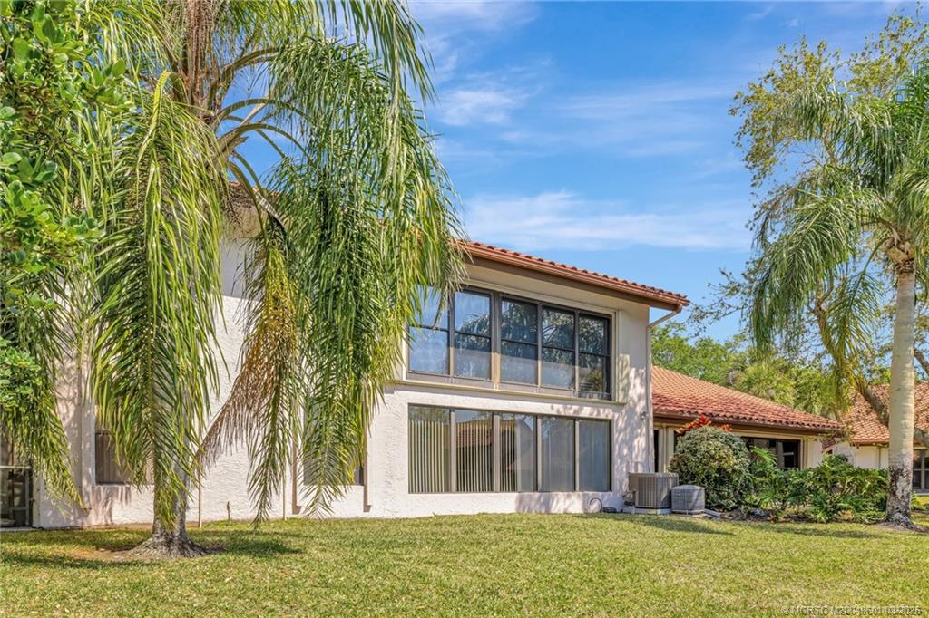 6040 Southeast Martinique Drive, Unit 102 Stuart, FL 34997 - Photo 38 of 52 front view of a house with a garden