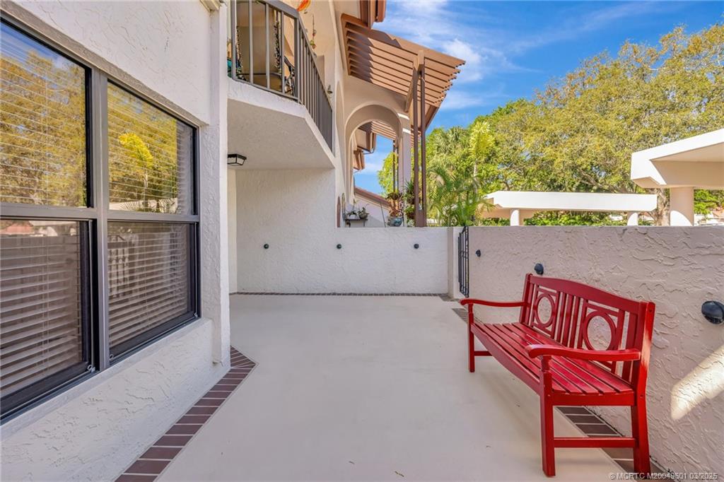 6040 Southeast Martinique Drive, Unit 102 Stuart, FL 34997 - Photo 4 of 52 a front view of a house with garage