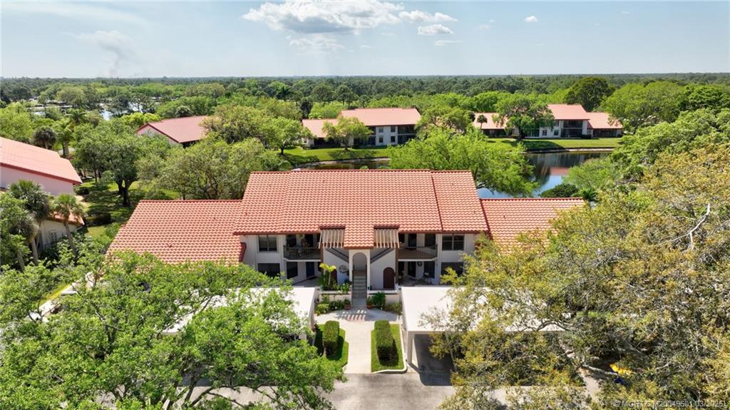6040 Southeast Martinique Drive, Unit 102 Stuart, FL 34997 - Photo 41 of 52 an aerial view of multiple house