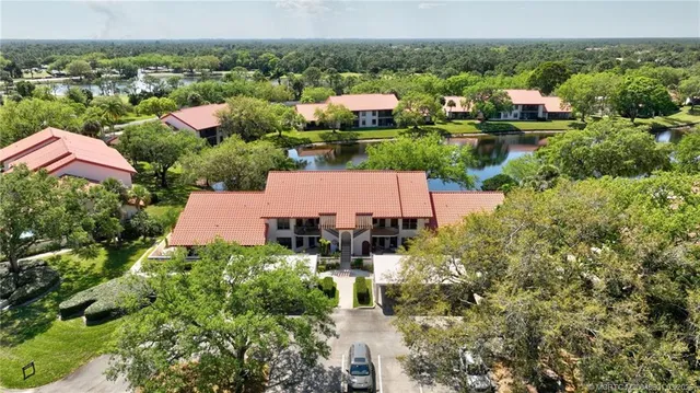 an aerial view of house with yard and lake view