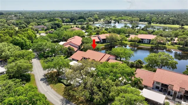 an aerial view of residential houses with lake