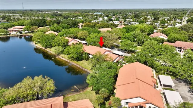 an aerial view of residential houses with outdoor space and swimming pool