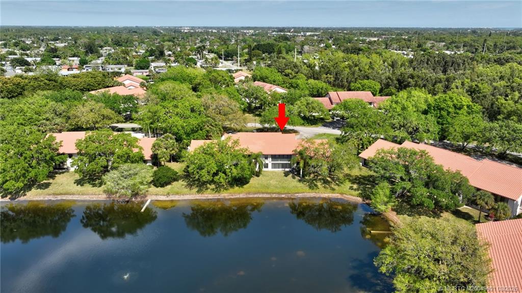6040 Southeast Martinique Drive, Unit 102 Stuart, FL 34997 - Photo 46 of 52 an aerial view of residential houses with lake