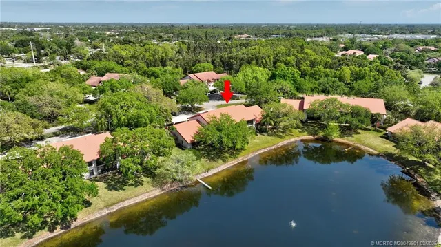 a view of a house with a yard and a pond