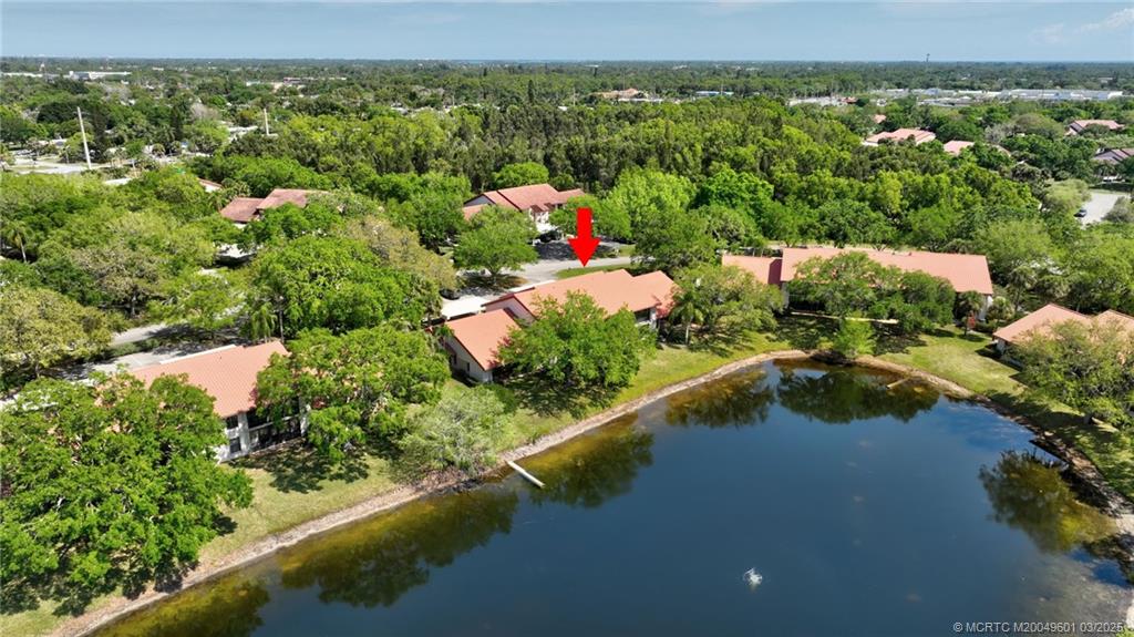 6040 Southeast Martinique Drive, Unit 102 Stuart, FL 34997 - Photo 47 of 52 an aerial view of residential houses with outdoor space and swimming pool