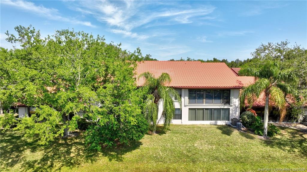6040 Southeast Martinique Drive, Unit 102 Stuart, FL 34997 - Photo 50 of 52 a view of a house with a yard