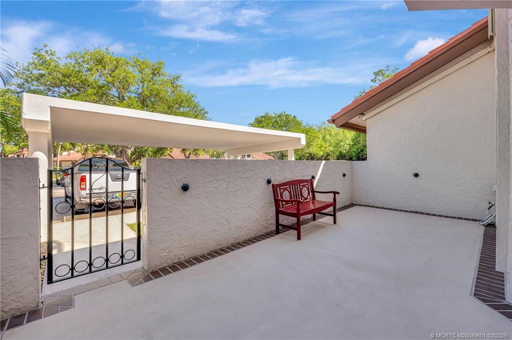 6040 Southeast Martinique Drive, Unit 102 Stuart, FL 34997 - Photo 5 of 52 a view of a patio with a table and chairs