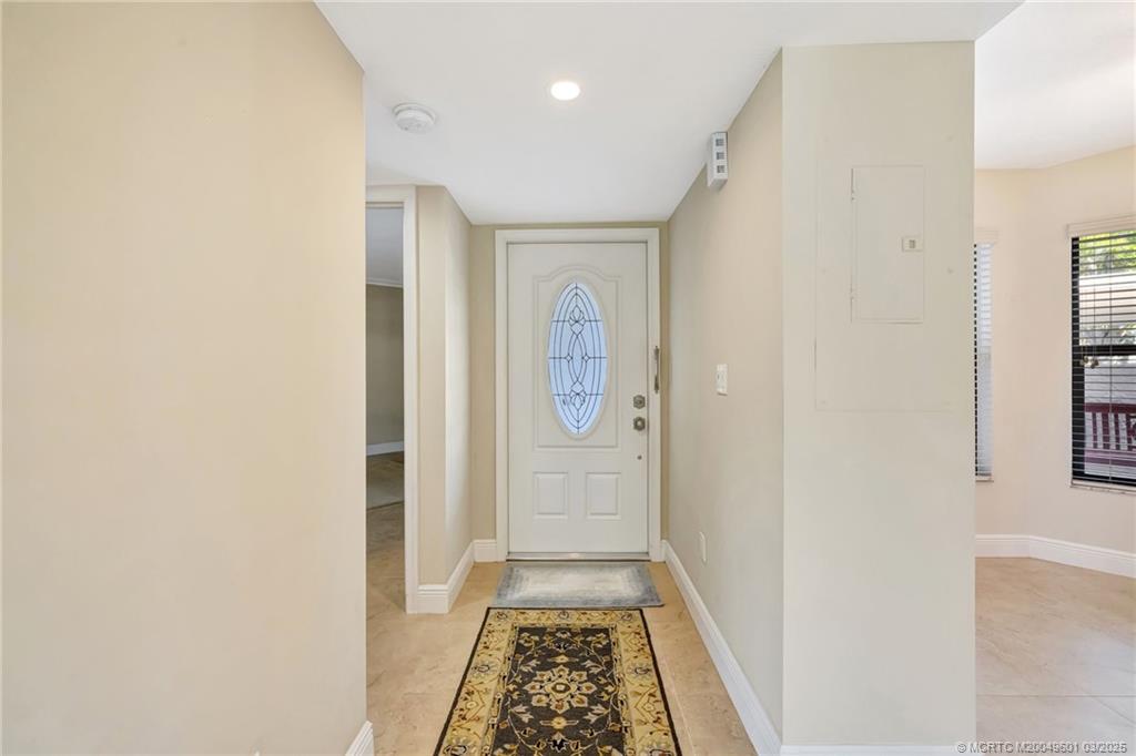6040 Southeast Martinique Drive, Unit 102 Stuart, FL 34997 - Photo 6 of 52 a view of hallway with wooden floor