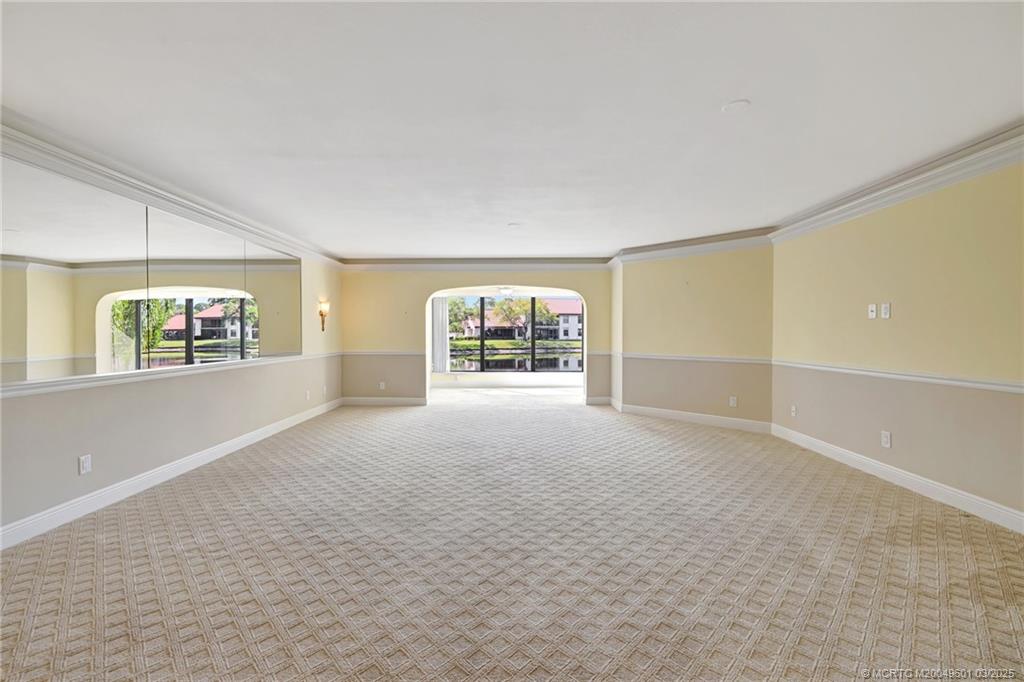 6040 Southeast Martinique Drive, Unit 102 Stuart, FL 34997 - Photo 7 of 52 a view of an empty room with a window and fire place