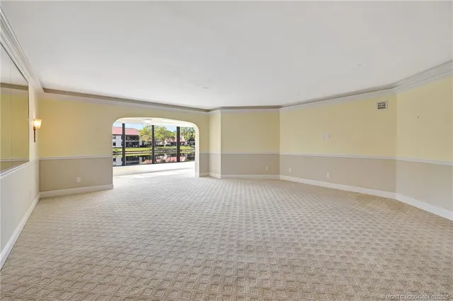 an empty room with windows and entrance