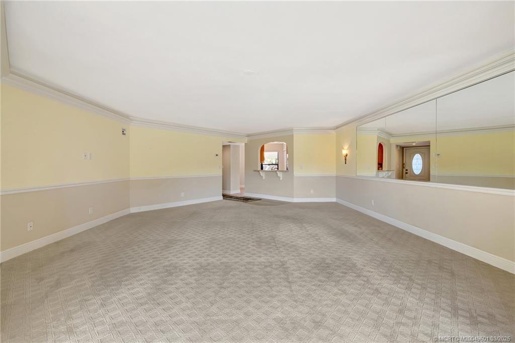 6040 Southeast Martinique Drive, Unit 102 Stuart, FL 34997 - Photo 9 of 52 an empty room with windows and entrance