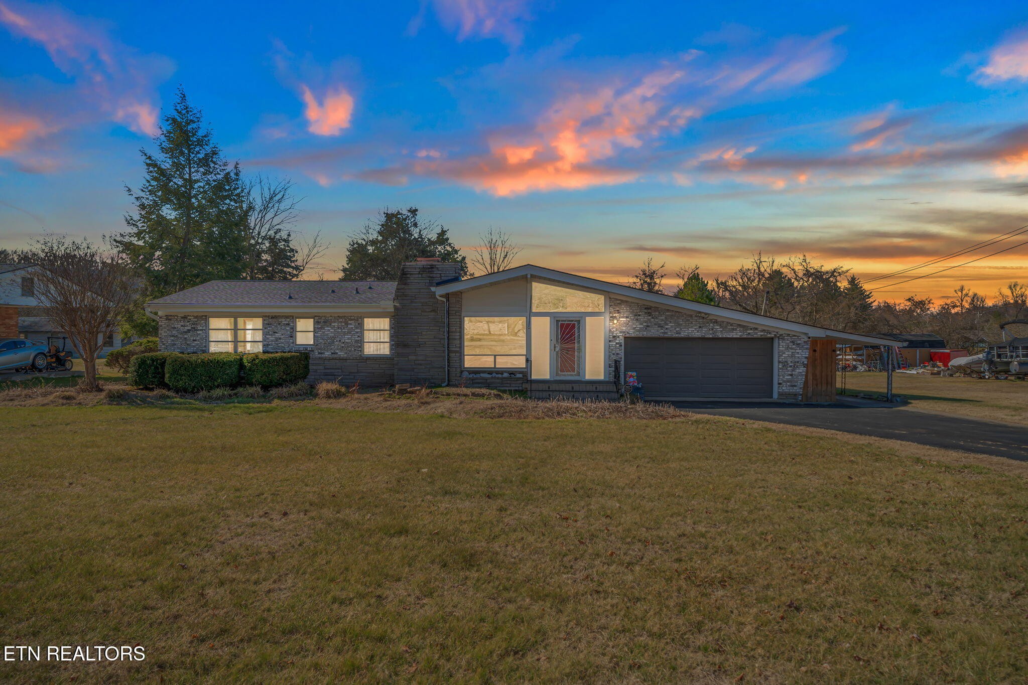 a front view of a house with a garden