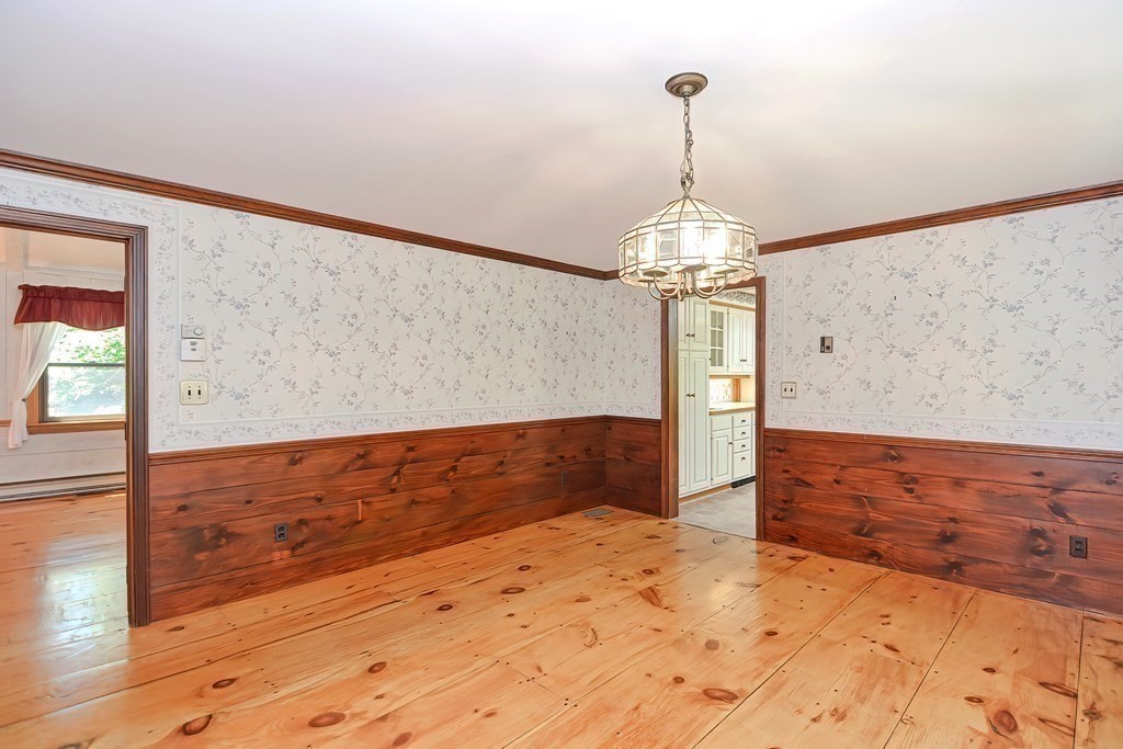 125 Westboro Road Upton, MA 01568 - Photo 17 of 41 a view of a livingroom with wooden floor and a chandelier