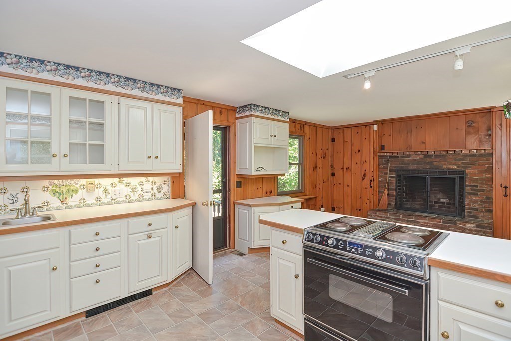 125 Westboro Road Upton, MA 01568 - Photo 6 of 41 a kitchen with a stove and white cabinets