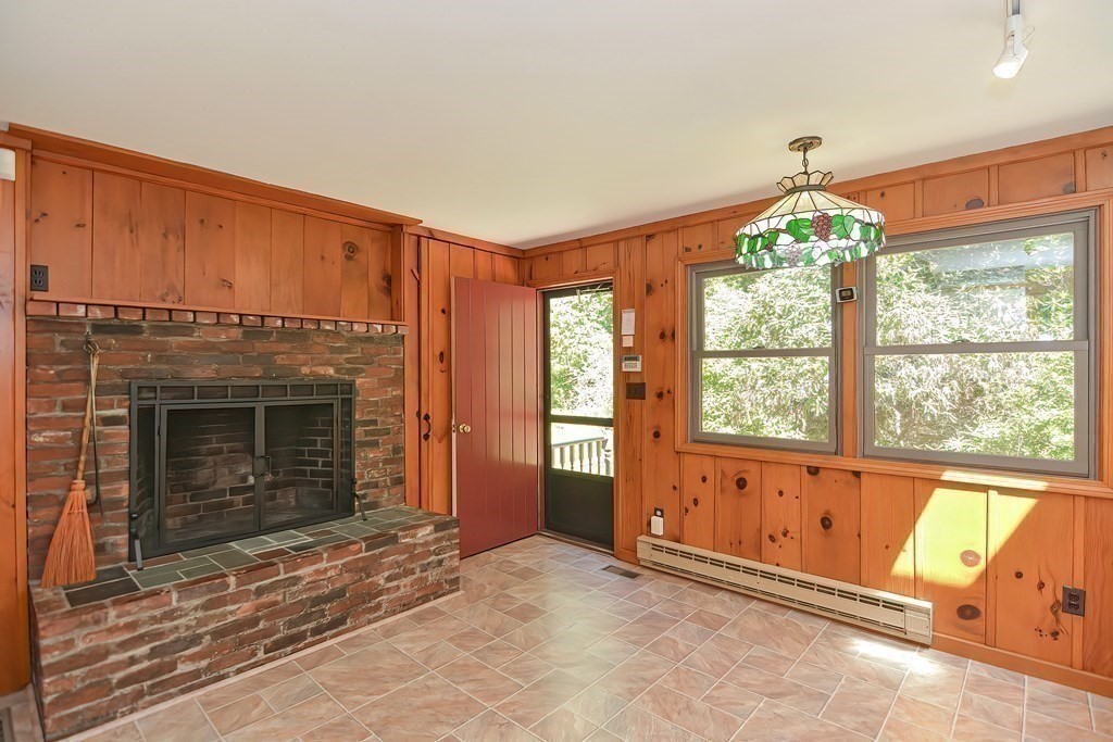 125 Westboro Road Upton, MA 01568 - Photo 9 of 41 an empty room with windows and fireplace