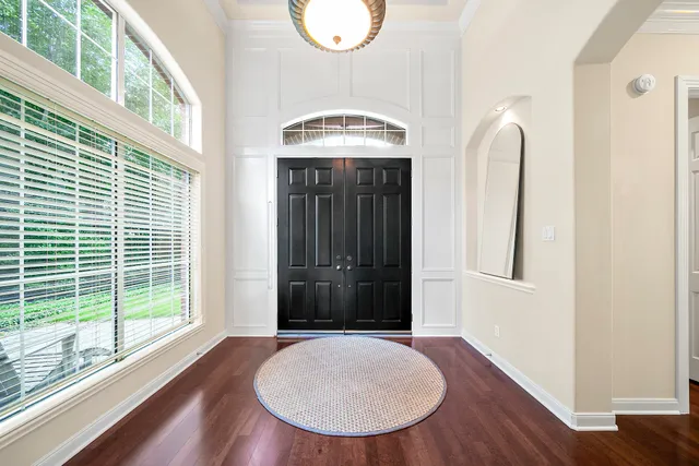 a view of an entryway with wooden floor and a window