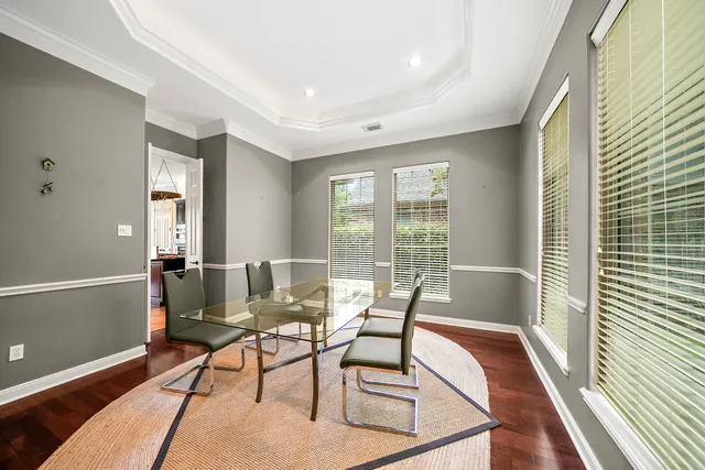 a dining room with furniture and wooden floor