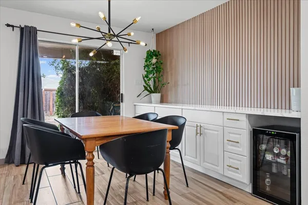 a view of a dining room with furniture and chandelier