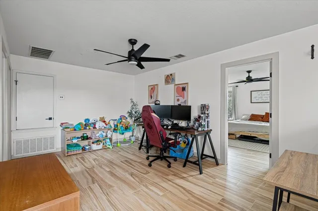 a view of a workspace with furniture and wooden floor