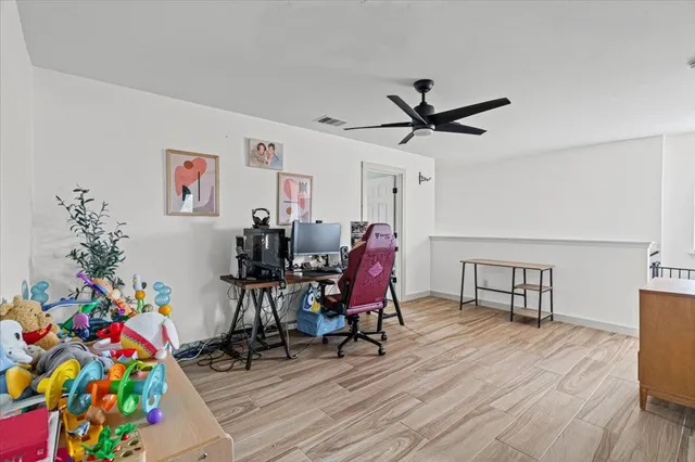 a view of a workspace with furniture and wooden floor