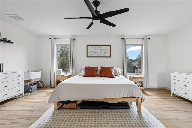 a bedroom with a bed and a window