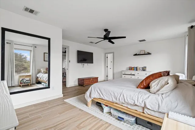 a bedroom with a bed and a flat screen tv