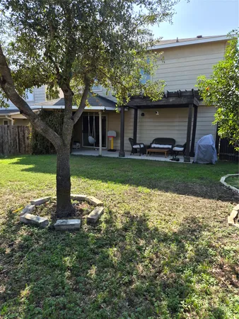 a backyard of a house with table and chairs