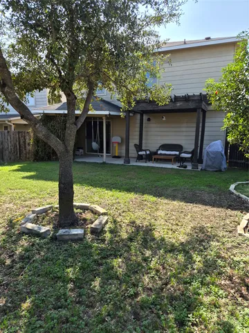 a backyard of a house with table and chairs