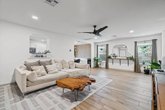 a living room with furniture and a wooden floor