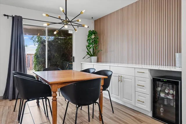 a view of a dining room with furniture and chandelier