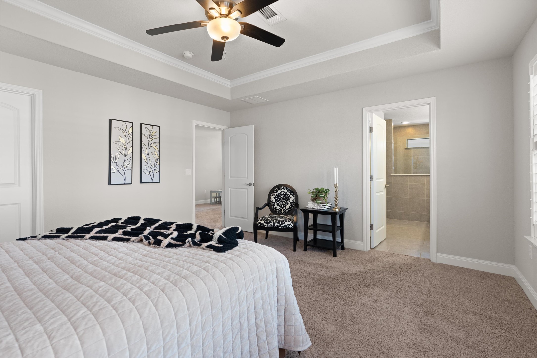 10502 Turnbull Loop, Unit 41 Austin, TX 78717 - Photo 15 of 35 a bedroom with a bed and a chandelier