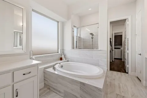 a bathroom with a bathtub and a sink