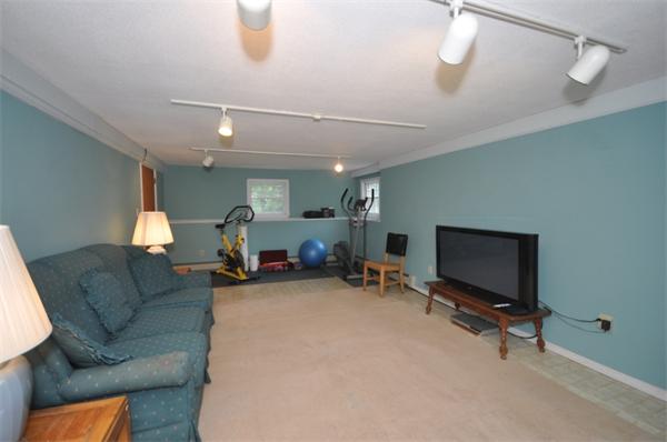 17 Middle Street Lexington, MA 02421 - Photo 12 of 13 a living room with furniture a flat screen tv and a window