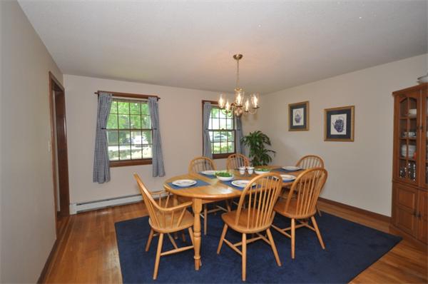 17 Middle Street Lexington, MA 02421 - Photo 3 of 13 a view of a dining room with furniture a chandelier and wooden floor