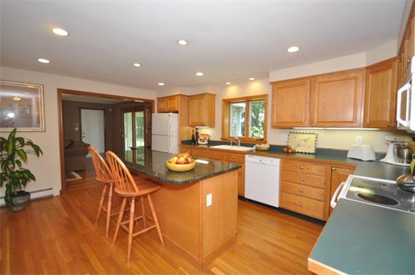 17 Middle Street Lexington, MA 02421 - Photo 4 of 13 a kitchen with stainless steel appliances kitchen island granite countertop a stove a sink and a refrigerator