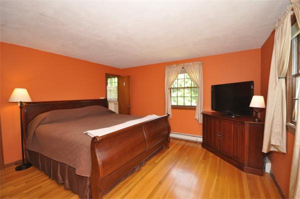 17 Middle Street Lexington, MA 02421 - Photo 8 of 13 a bedroom with a bed and a flat screen tv