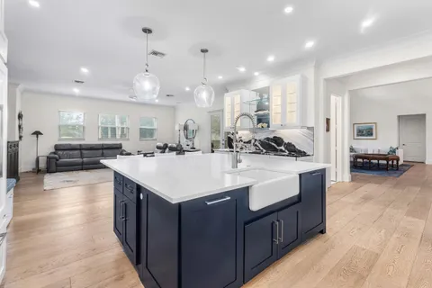 a kitchen with stainless steel appliances a sink stove and cabinets