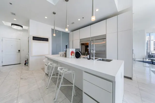 a kitchen with stainless steel appliances kitchen island granite countertop a sink and cabinets