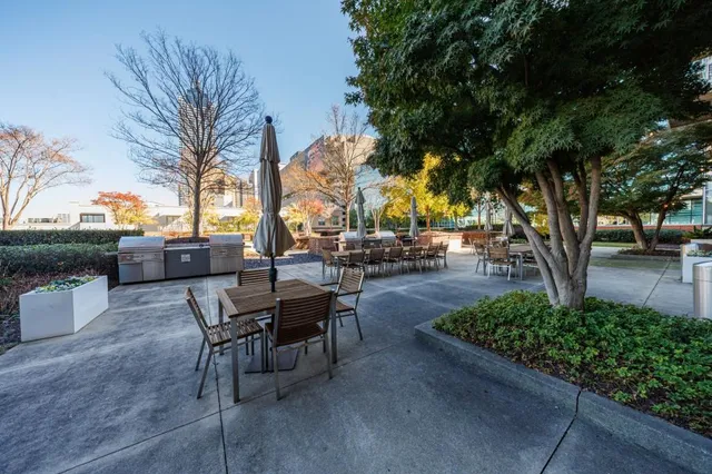 a view of a backyard with table and chairs