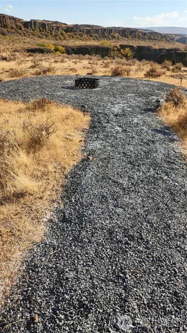 a view of a yard with wooden fence