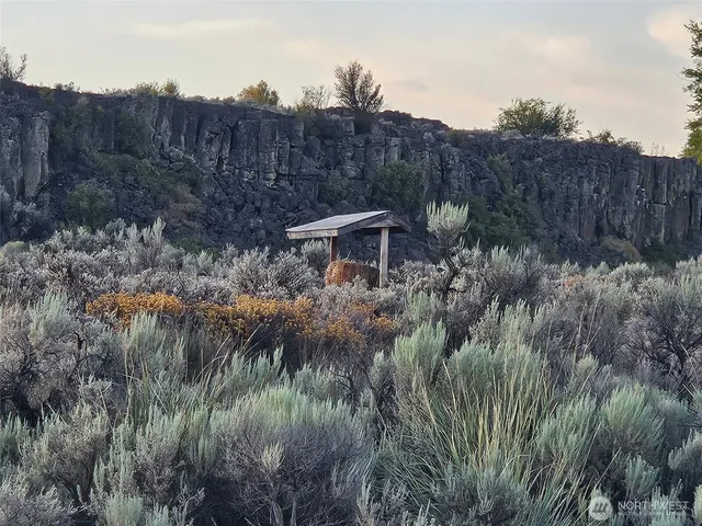 a bed sitting in a bedroom next to a cabinet