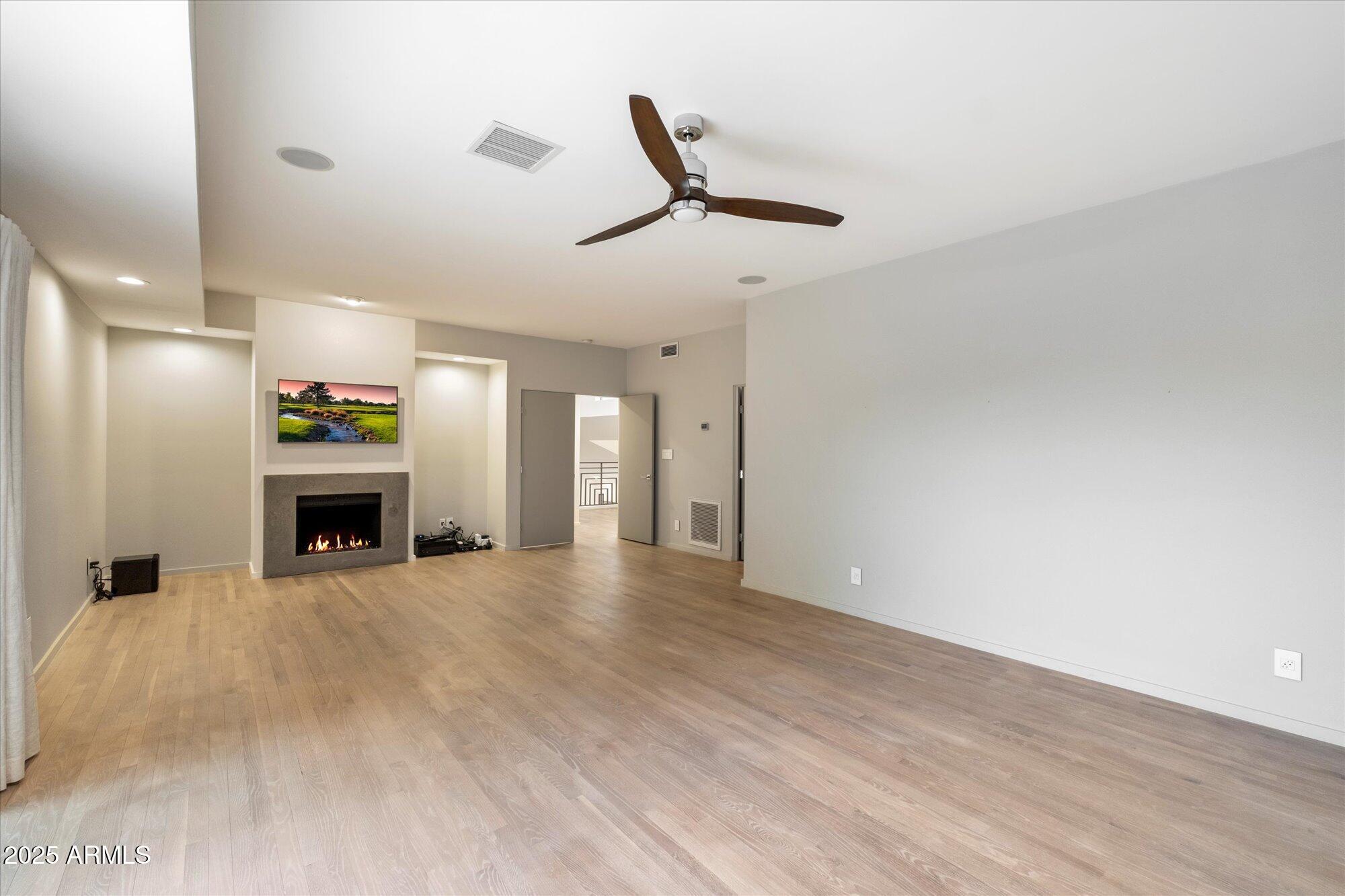 25 West Frier Drive Phoenix, AZ 85021 - Photo 21 of 43 a view of an empty room with a fireplace and a window