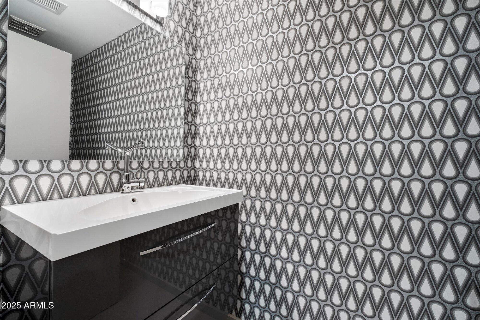 25 West Frier Drive Phoenix, AZ 85021 - Photo 31 of 43 a bathroom with a sink and a mirror