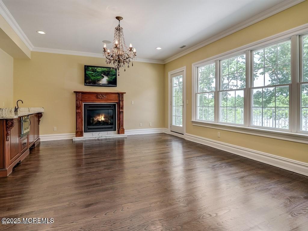 100 Richdale Road Colts Neck, NJ 07722 - Photo 18 of 31 a living room with fireplace furniture and a wooden floor