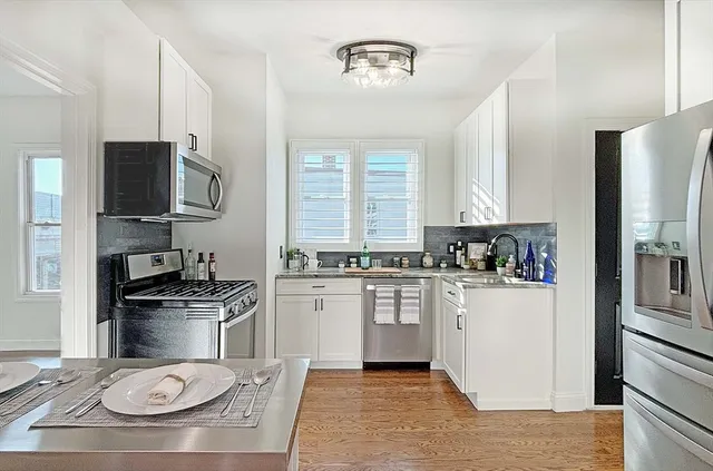 a kitchen with a stove a sink and a refrigerator
