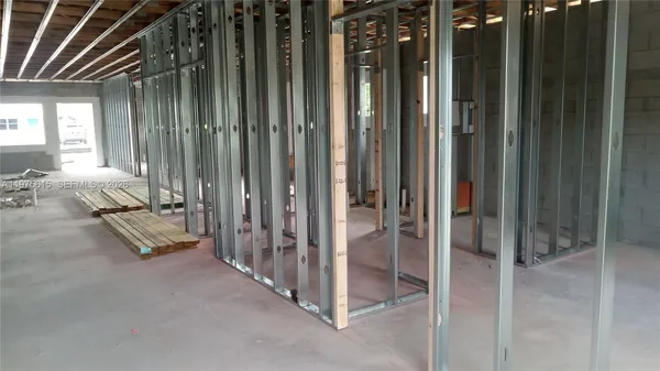 a view of a room with wooden floor and windows