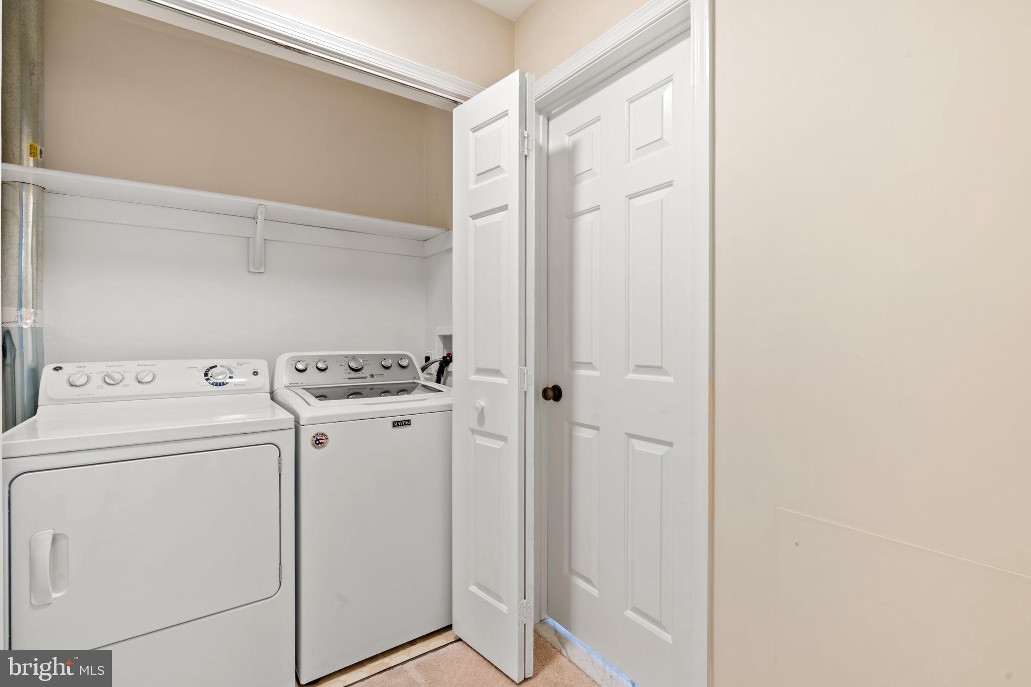 115 Roumfort Road, Unit 26 Philadelphia, PA 19119 - Photo 24 of 33 a utility room with dryer and washer