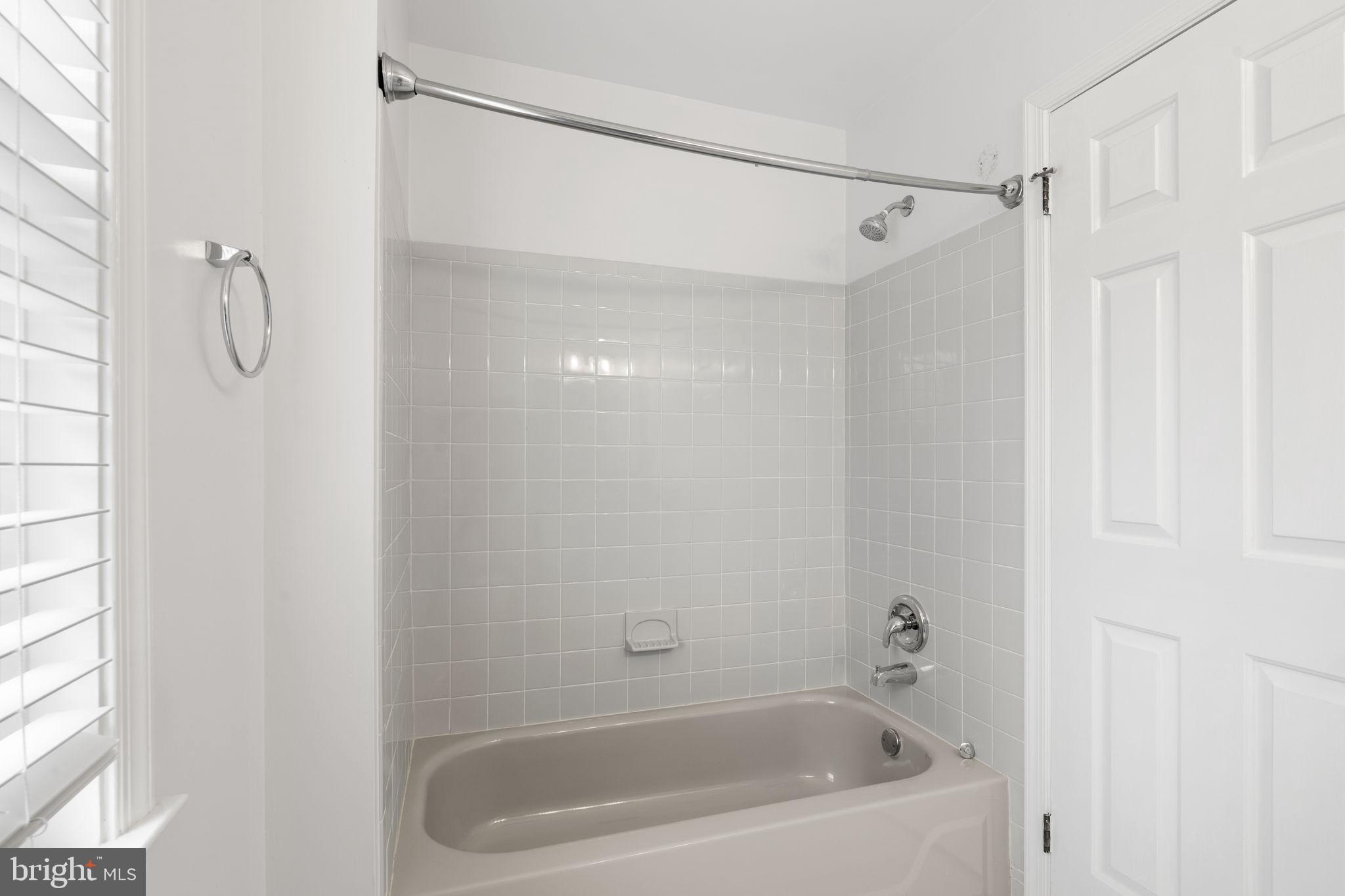 115 Roumfort Road, Unit 26 Philadelphia, PA 19119 - Photo 27 of 33 a bathroom with a shower and a bath tub